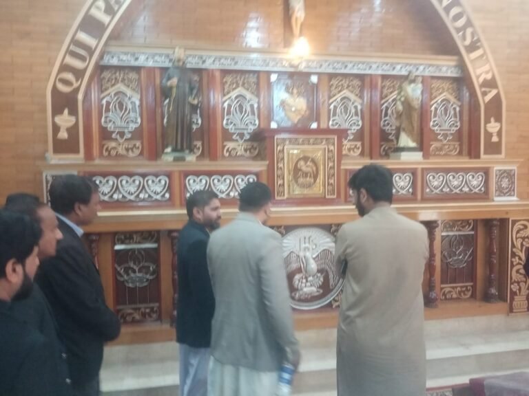 Rev. Fr. Shakeel explaining Mr. Sultan the design and structure of the Altar