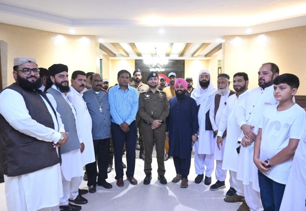 A group photo with officials and Christian, Muslim, and Sikh religious leaders