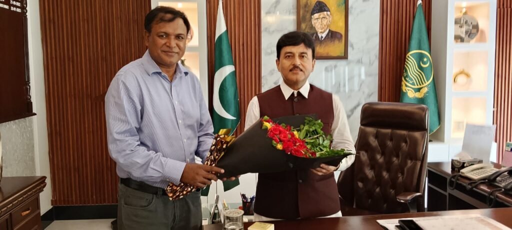 Mr. Shahzad Lawrence is presenting a bouquet to commissioner Gujranwala
