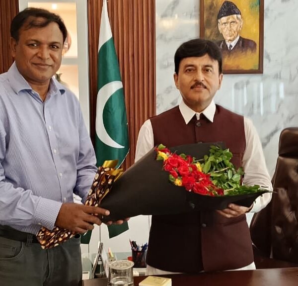 Mr. Shahzad Lawrence is presenting a bouquet to commissioner Gujranwala