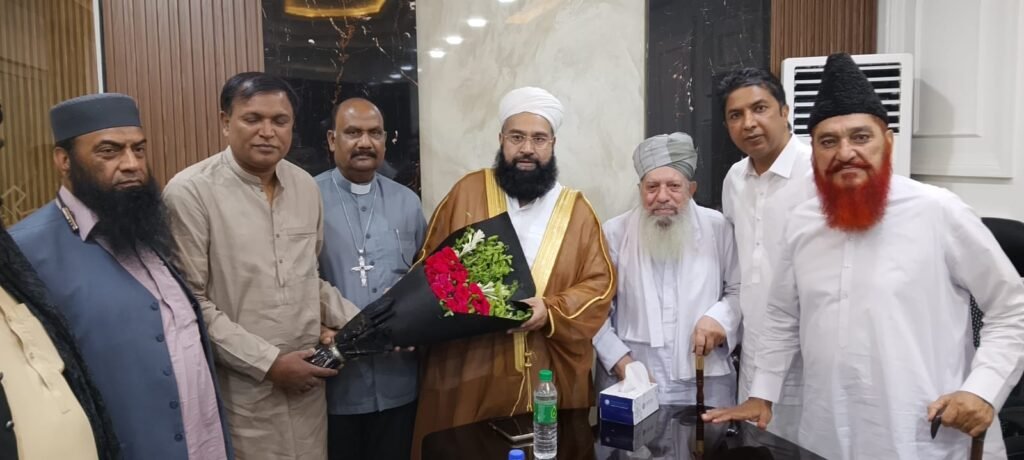 Shahzad Lawrence presenting flowers to Hafiz Tahir Ashrafi
