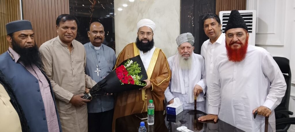 Shahzad Lawrence presenting flowers to Hafiz Tahir Ashrafi