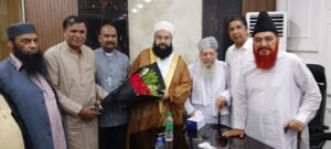 Shahzad Lawrence presenting flowers to Hafiz Tahir Ashrafi