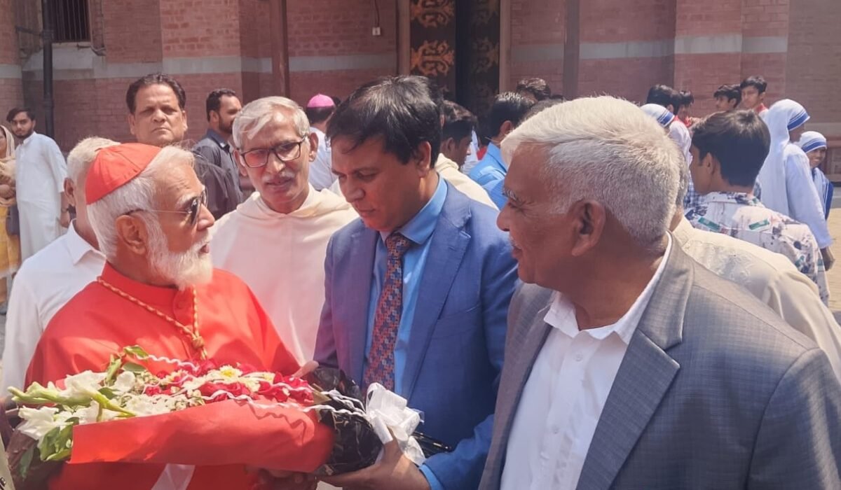 Presenting bouquet of flowers to His Eminence Cardinal Joseph Coutts