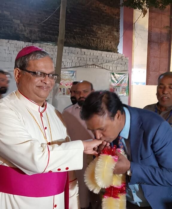 kissing the episcopal ring of the Catholic Archbishop