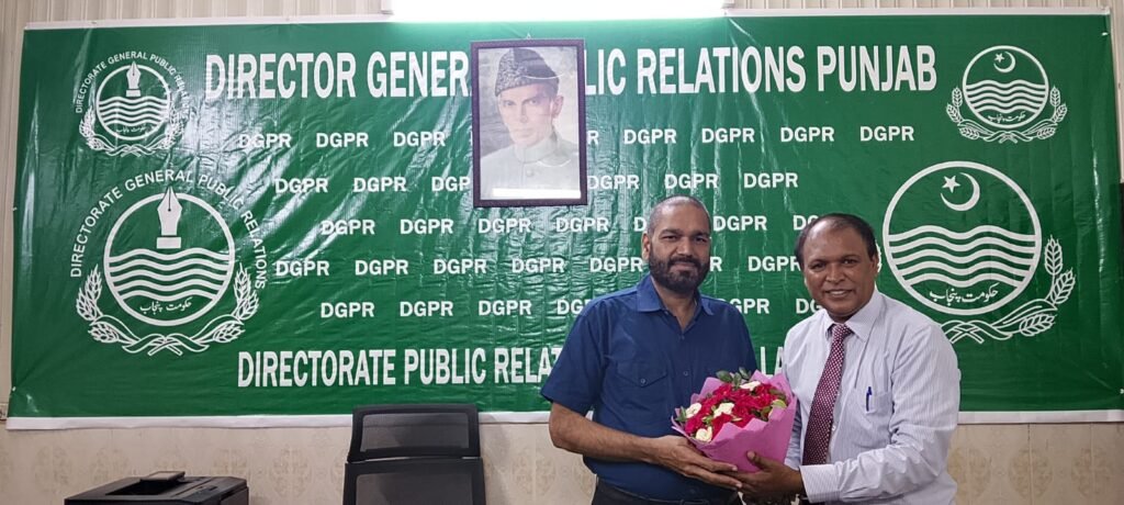 Shahzad Lawrence presenting flower to Mr. Munawar Hussain